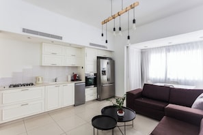 Enjoy a spacious living area with a kitchen, dining space, and large window.
