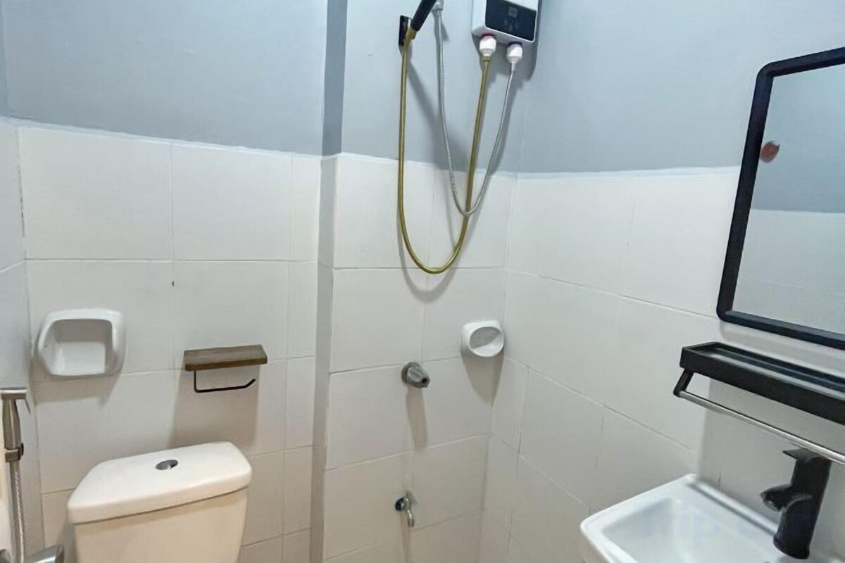 A bathroom with a toilet, a sink, and a shower.