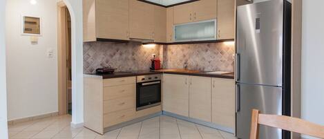 Apartment | Private kitchen | Full-sized fridge, oven, toaster, cookware/dishes/utensils