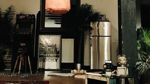 A room with a punching bag, a dartboard, a refrigerator, and a welcome sign. - Unique yoga loft! Quiet room for courses, seminars, workshops! (Sinsheim)