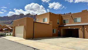 A modern building with a garage and a driveway. - Moab Rim Views! I Pet Friendly I Garage I Pool & Hot Tub (Moab)