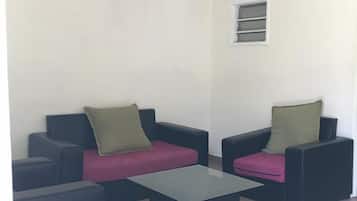 Comfort Bungalow, 1 King Bed | Living area | 14-inch flat-screen TV with satellite channels, first-run films