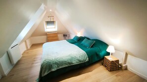 Cozy bedroom with a single bed, bedside table, and window.
