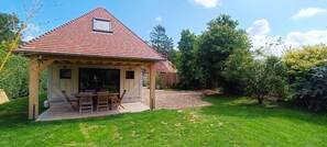 Relax on the porch with a view of lush greenery and a tranquil setting.