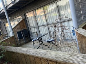 Relax on the outdoor patio with a comfortable chair and enjoy the serene surroundings.
