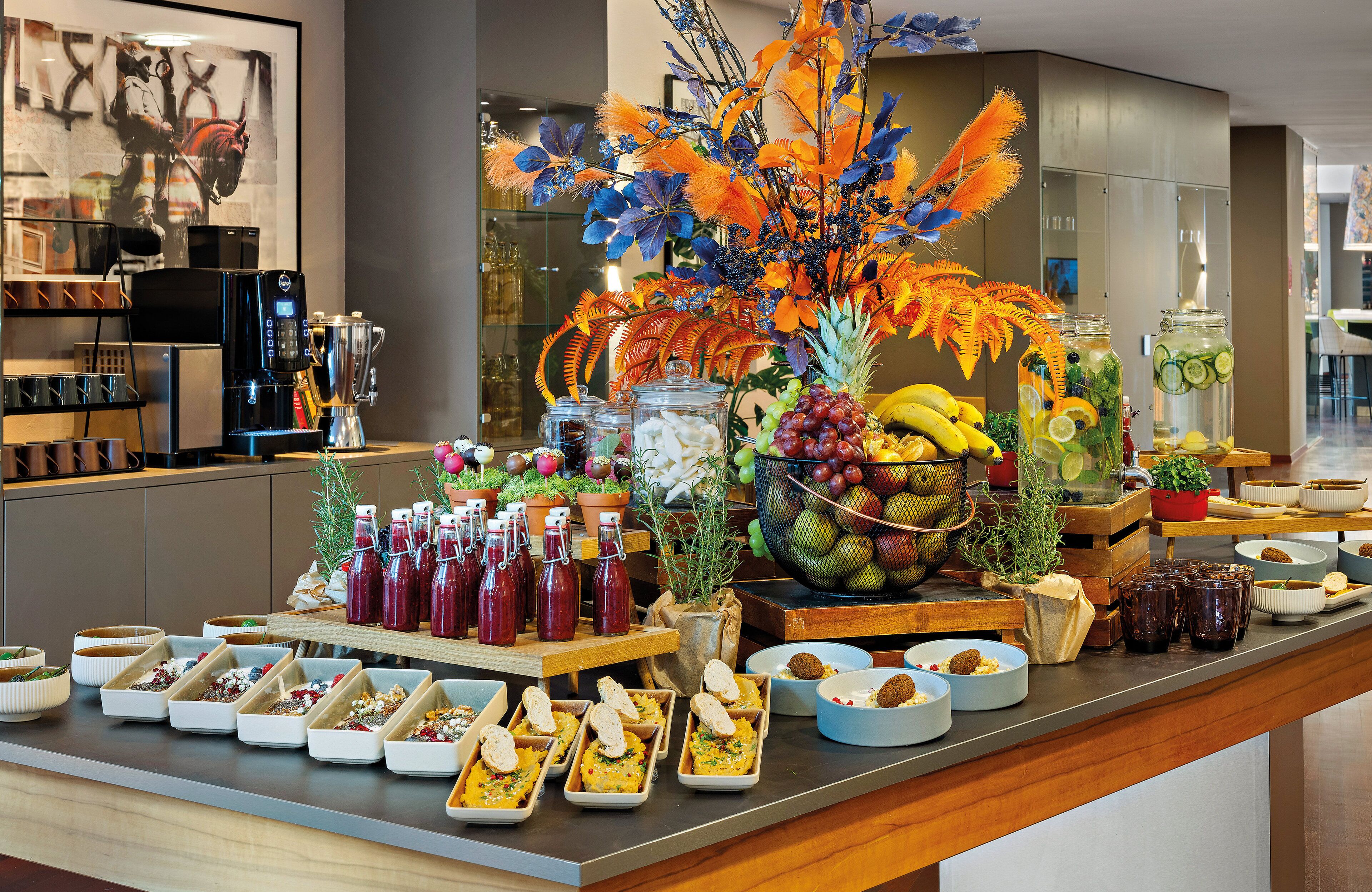 A buffet with various food items and beverages, including fruits, salads, and drinks.
