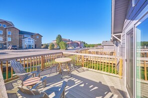 A wooden deck with outdoor seating, a clear view of the neighborhood, and a building labeled "Bolstad West". - Romantic, Walk to town & beach (Akari#3) (Long Beach)