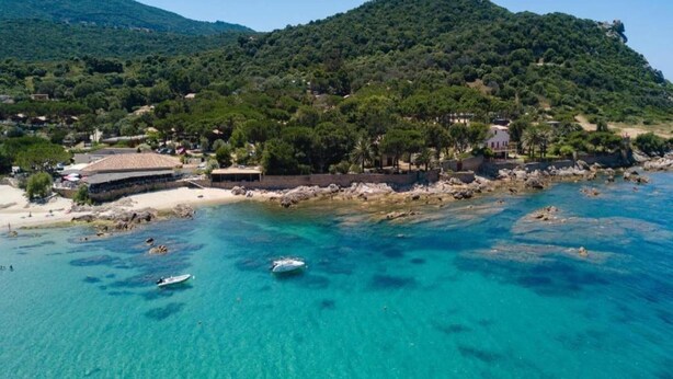 A coastal area with clear turquoise waters, rocky shoreline, and a hill with dense greenery. - Propriano Chalet near Sandy Beaches (Propriano)