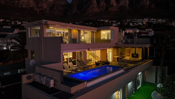 A modern two-story house with a rooftop pool, large windows, and a balcony. - 26OnFirst: UPS, Sea Views & Personalised Service (Cape Town)