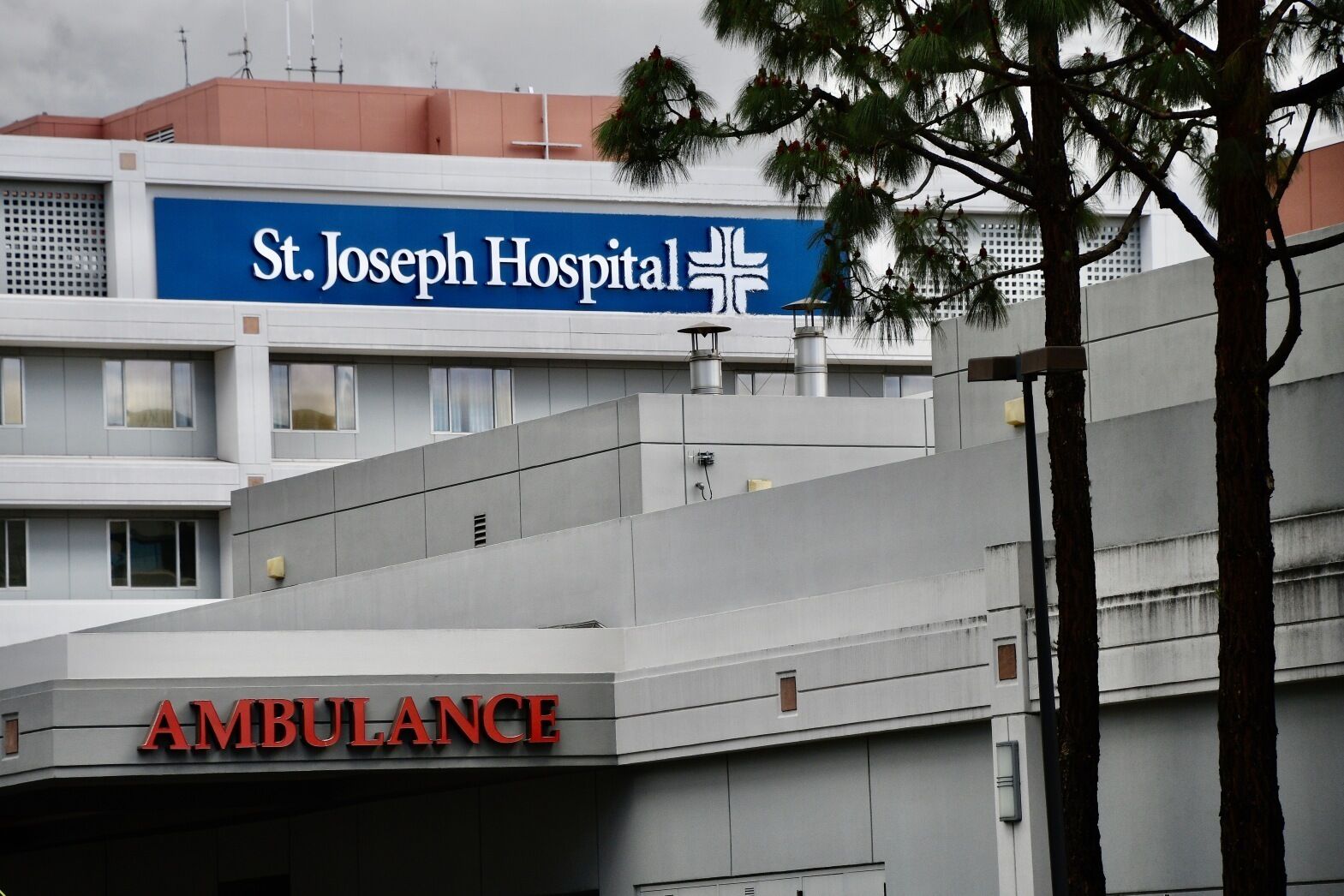 A hospital building with a sign for St. Joseph Hospital and an ambulance entrance.