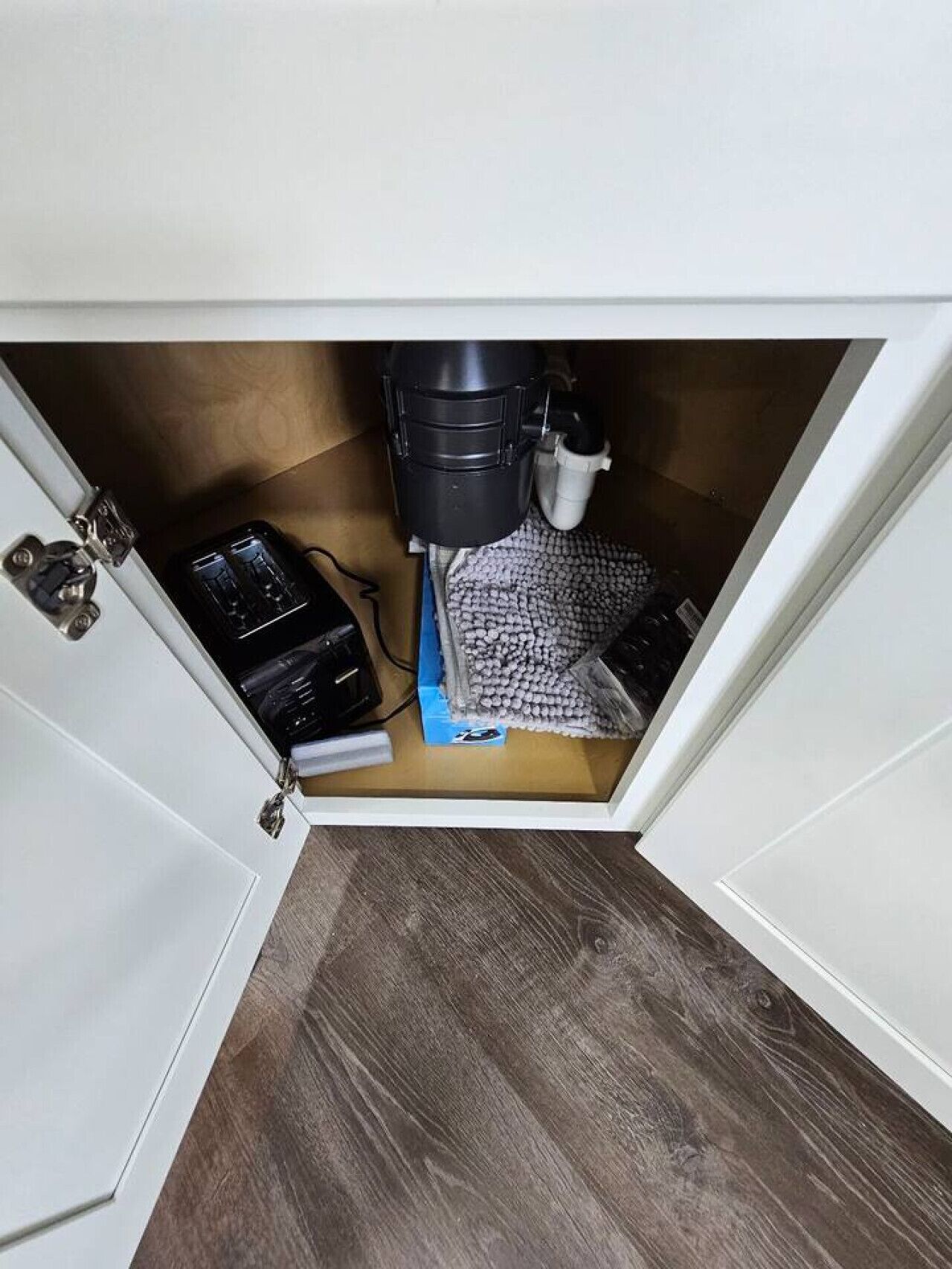 Eine Küche mit Mikrowelle, Toaster und Kaffeemaschine unter einem Schrank.