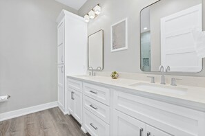 A modern bathroom with two sinks, a large mirror, and a cabinet. - Beach House - Totally Beachin by PHG (Panama City Beach)
