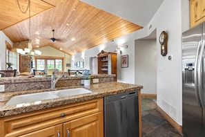 A kitchen with granite countertops, wooden cabinets, a stainless steel dishwasher, and a built-in oven. - KBM Resorts | Town Pointe | 1 level with views of mountains, Walk to Main and Town Lift, Elevator access, Parking, A/C! TPC-301c (Park City)