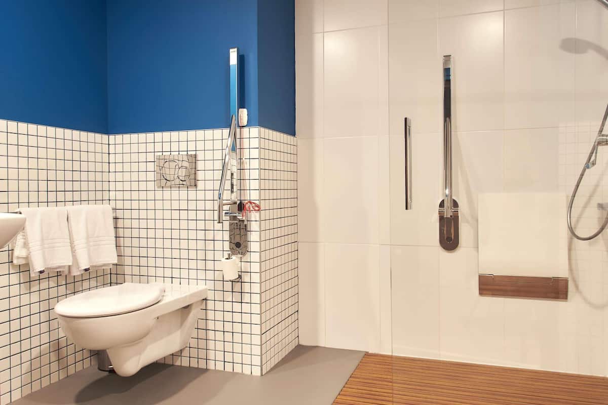 Une salle de bain avec des toilettes, une douche et un lavabo.