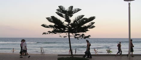 On the beach, white sand, sun loungers, beach umbrellas