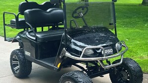 A black golf cart with a protective roof, large off-road tires, and a steering wheel. - 🐎 2 Miles to Flintfields, Fenced Yard pet friendly, FREE RENTAL Golf Cart (Williamsburg)