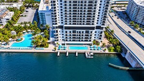 A high-rise hotel with a swimming pool, dock, and a bridge. - This impressive 2-bedroom corner apartment combines elegance, comfort, and breathtaking views (Hollywood)