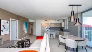 A modern apartment with a living room, dining area, kitchen, and a balcony with a city view. - This impressive 2-bedroom corner apartment combines elegance, comfort, and breathtaking views (Hollywood)