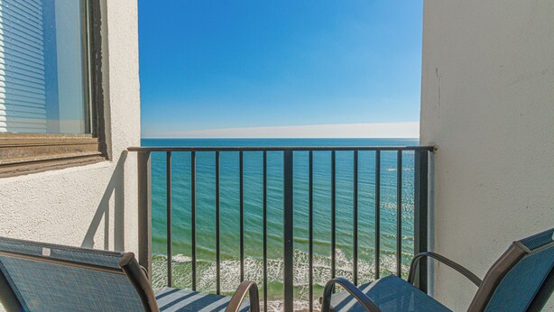 A balcony with two chairs facing a clear blue sea. - NEW! Palace Resort TRUE Oceanfront STUDIO Condo (Myrtle Beach)