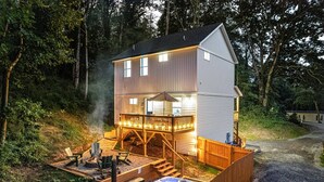 A two-story house with a deck, outdoor hot tub, and a fire pit. - Fall Getaway in Asheville w/Hot Tub & Fire Pit! (Asheville)