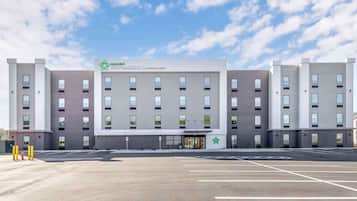 Extended Stay America features a modern, symmetrical design with a central entrance and a green star logo.