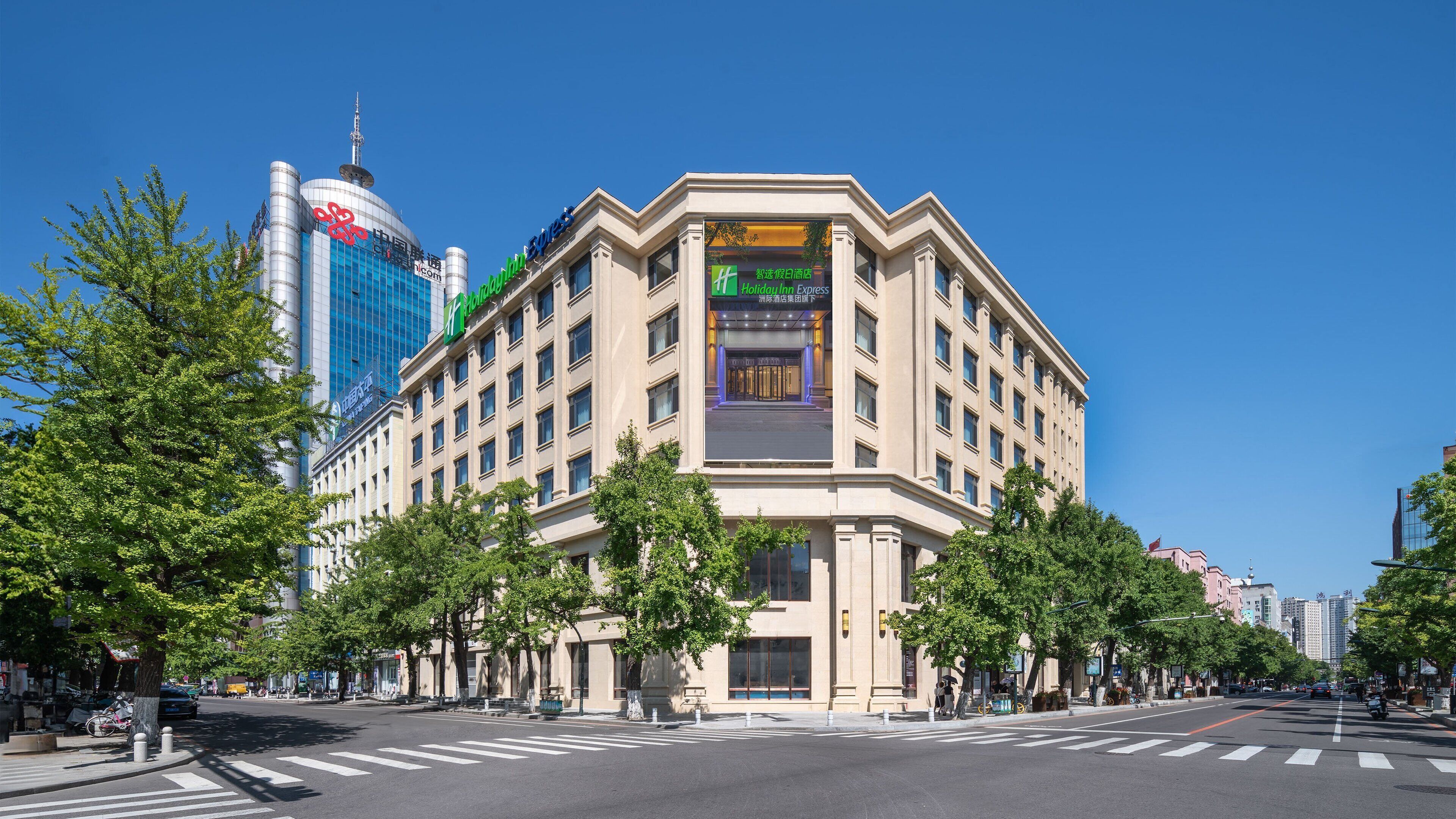A hotel with a prominent entrance, large windows, and a modern facade.