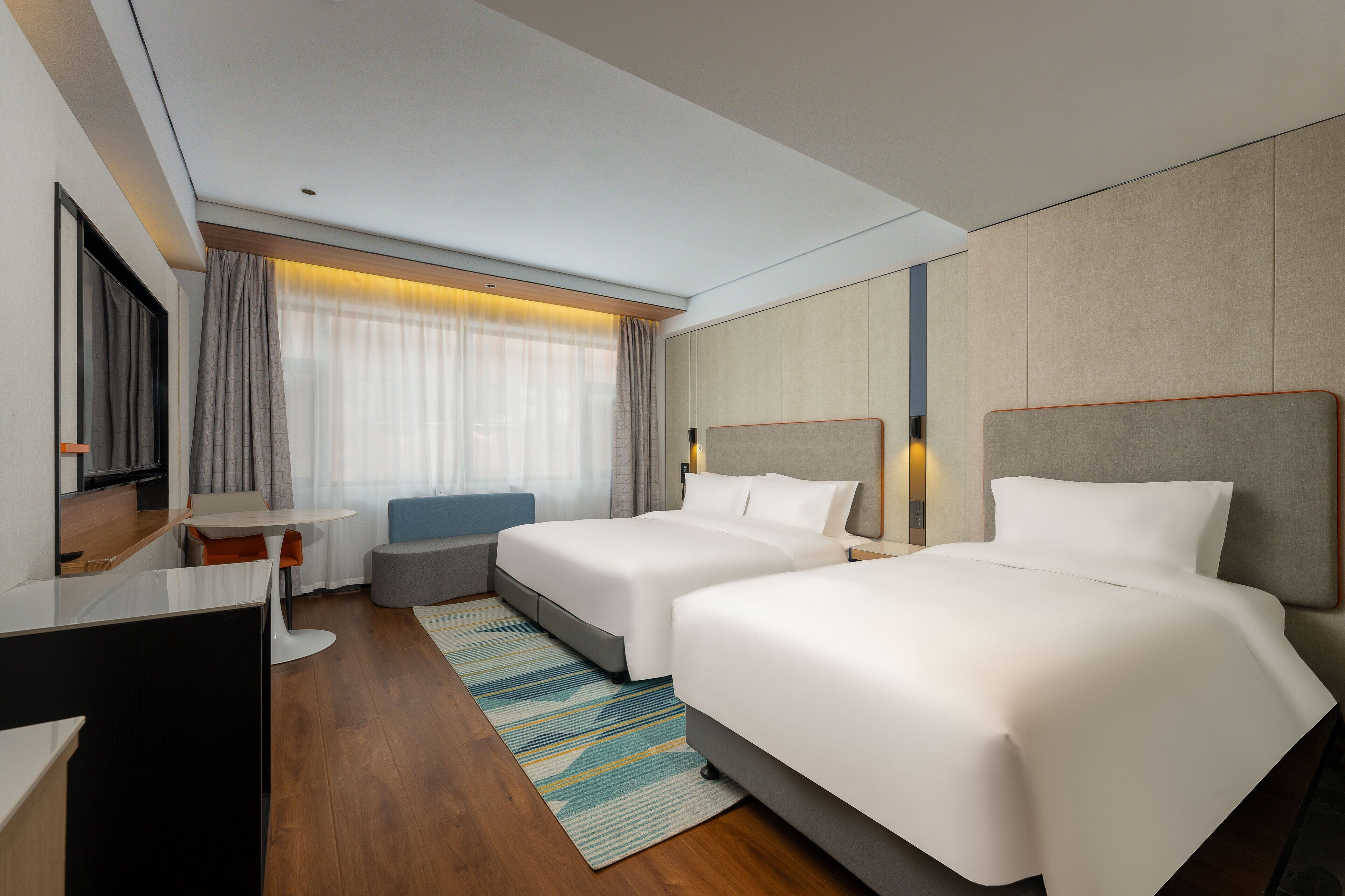Premium bedding, desk, laptop workspace, blackout drapes
