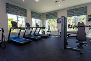 A gym with treadmills, a rowing machine, and a weight bench. - Outstanding 5BDR Disney Vacation (Kissimmee)