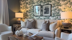 Relax in this stylish living room with a comfortable sofa, coffee table, and armchair.
