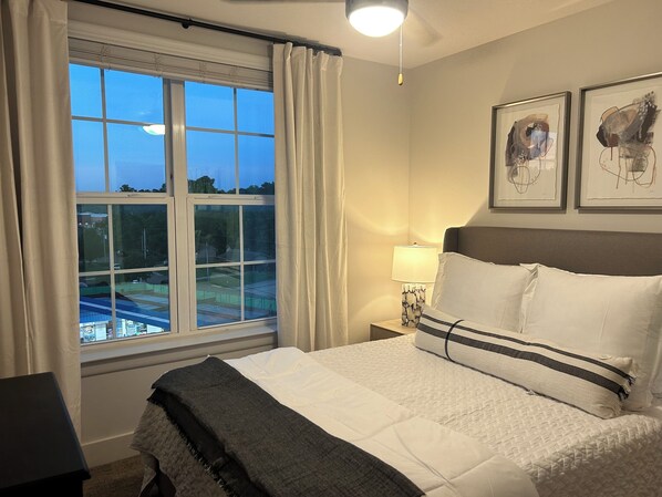 Relax in comfort with a large bed, nightstand, and stunning golf course views.