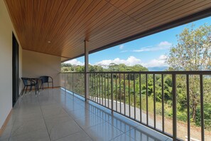 A balcony with a view of greenery and a clear sky. - Cozy Mountain Apt - For families - pool & Wi-Fi #4 (Platanillo, Baru)