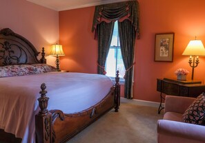 A bedroom with a large bed, two bedside lamps, a dresser, and a window with curtains. - Happy Moo's Fink Family Farm, where cows & guests are free to enjoy our 50 acres (Versailles)