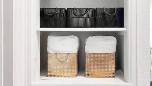 A white storage unit with three drawers and two wicker baskets on the top shelf. - Shocker Shack - 2K - Near WSU, Park - Fenced Yard (Wichita)