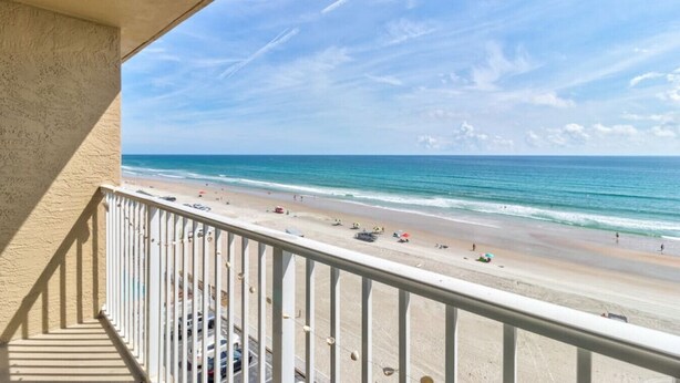A balcony with a view of a beach. - Sunrise Seven Deluxe Oceanfront Condo (Daytona Beach)