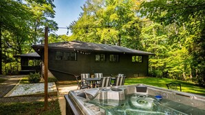 A house with a hot tub, outdoor seating, and a garden.