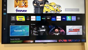 A TV screen displaying a streaming service interface with various app icons and a YouTube TV advertisement. - Traveler’s Den in Medford (Medford)