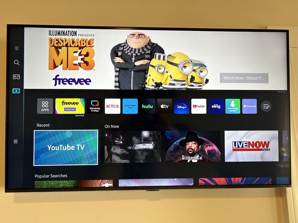 A TV screen displaying a streaming service interface with various app icons and a YouTube TV advertisement.