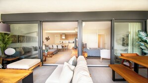 Una sala de estar moderna con un sofá, una mesa de centro y un comedor con sillas y una mesa.