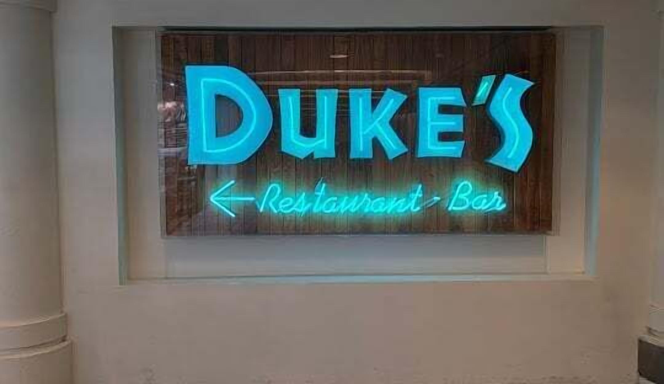 A neon sign for Duke's Restaurant Bar.