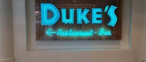 A neon sign for Duke's Restaurant Bar.