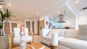 A modern living room with a wooden coffee table, a starfish decoration, and two candles.