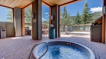 A hot tub area with a view of a mountain and trees.