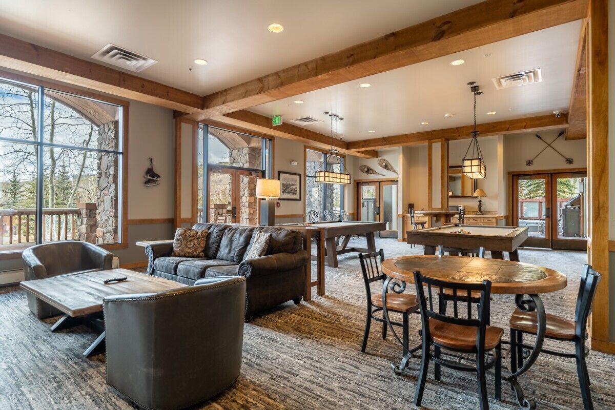 A spacious living area with a fireplace, a dining table, and comfortable seating.