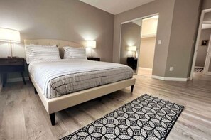 Cozy retreat with a large bed, bedside tables, and a patterned rug.