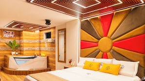A modern hotel room with a large bed, a built-in bathtub, wooden flooring, and a unique ceiling design. - MONTREAL MAGDALENA HOTEL  (Lima)