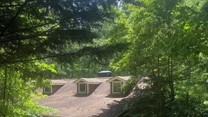 A house with a sloped roof, a covered porch, and a garage.