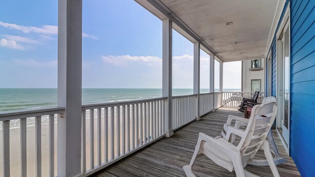 A wooden deck with white railings overlooking a beach. - Sweeping Views, Oceanfront Porches, Private Beach Access, Close to Lighthouse - Double Stack (Folly Beach)