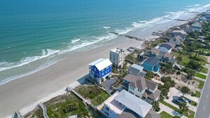 An aerial view of a coastal residential area with houses, a beach, and a pier. - Sweeping Views, Oceanfront Porches, Private Beach Access, Close to Lighthouse - Double Stack (Folly Beach)