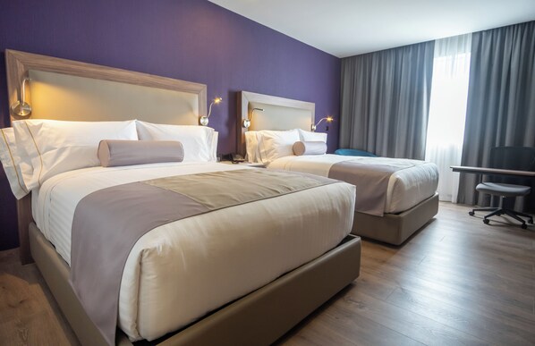 A hotel room with two beds, a desk, and a chair. - Sheraton Guadalajara Expo (Zapopan)