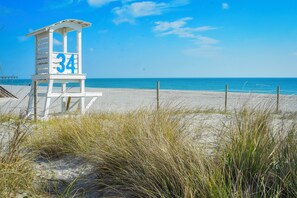 A lifeguard tower with the number 34 on a beach.